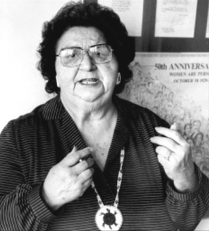 Photo of Mary Two-Axe Earley speaking and gesturing with her hands