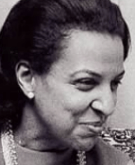 An African-American woman, black hair swept back from forehead, smiling, in 3/4 profile