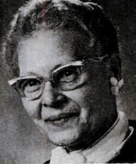 A smiling older Black woman wearing glasses