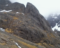 Douglas Boulder (Ben Nevis, Highland Scotland) and East Gully in May 2014 with cloud in background and a few snowpatches