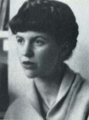 A black-and-white photo of a woman with her hair up, looking to the left of the camera lens