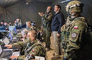 Mark Esper visits with Polish soldiers training with American troops in Germany in 2018. Esper would later reactivate the Army's V Corps in Poland as DOD increasingly faced off against Russia