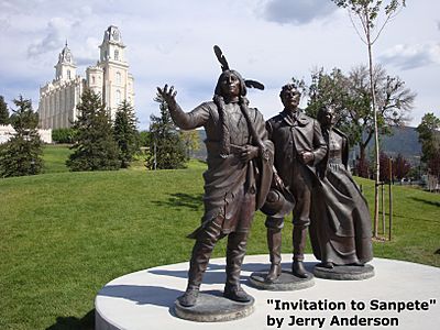 A statue of a Native American with pioneer settlers at Pioneer Heritage Gardens in Manti, Utah.