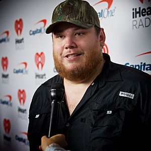 Country music singer Luke Combs speaking into a microphone