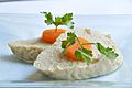Gefilte fish topped with slices of carrot.jpg