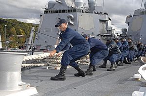 Defense.gov News Photo 100930-N-2855B-251 - U.S. Navy sailors aboard the guided missile destroyer USS Bainbridge DDG 96 haul in a mooring line while mooring the ship in Faslane Scotland on