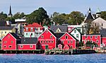 Red wooden houses at the shore