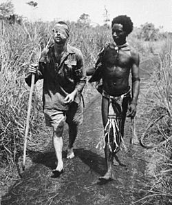 Australian Private George "Dick" Whittington aided by Papuan orderly Raphael Oimbari.