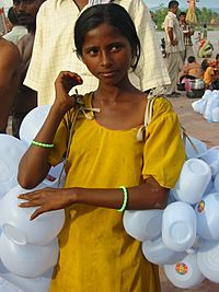 A girl selling plastic containers for carrying Ganges water, Haridwar