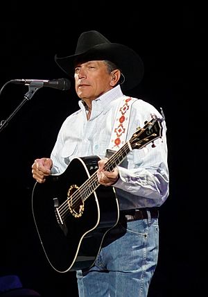 A photo of George Strait holding a guitar