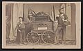 Bernard Tobey, a double amputee and his son, wearing Union sailor uniforms, standing beside a small wagon displaying Secretary of War Edwin Stanton's dispatch on the fall of Fort Fisher) - LCCN2017659614