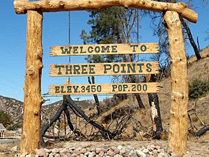 Three Points welcome sign and fire-burned trees