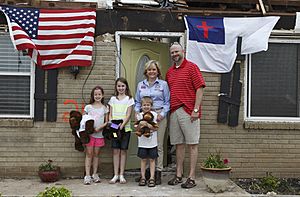 Oklahoma Gov. Mary Fallin, second from right, stands with a family that survived the May 20, 2013, tornado in Moore, Okla., May 28, 2013 130528-Z-VF620-4765