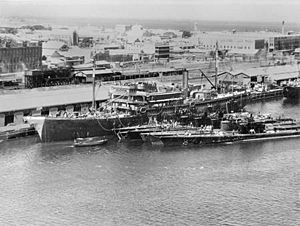 USS Holland (AS-3) tending submarines at Fremantle, Australia, on 5 March 1942 (AWM 302625)