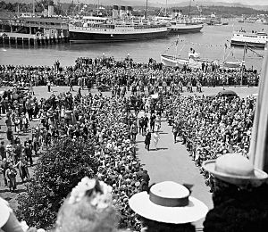 His Majesty King George VI and Her Majesty Queen Elizabeth coming up the walkway with a view of the harbour of Victoria in the background