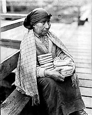 Nootka woman with baskets for sale that she made
