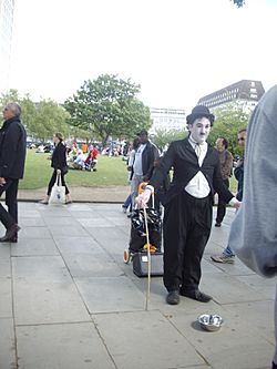 'Charlie Chaplin' impersonator on the river Thames walkway in London.