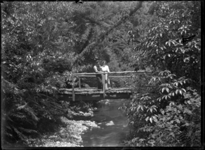 Albert Percy and Laura Godber on a footbridge over the Korokoro Stream. ATLIB 224722