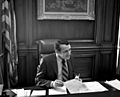 Harvey Milk in 1978 at Mayor Moscone's Desk