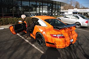 Ralph Lauren getting in his orange 997 GT3 RS