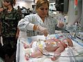 A Resperatory Therapist treating a newborn child Pulaski County Technical College Respiratory Therapist Program