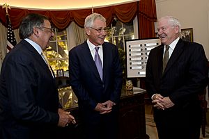 Secretary of Defense Chuck Hagel, center, speaks with former Secretary of Defense Robert Gates, right, and former Secretary of Defense Leon Panetta at the Peace Through Strength Forum and Awards dinner at 131116-D-BW835-1440
