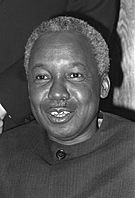 Candid shot of Mwalimu Julius Kambarage Nyerere looking just past the camera, speaking, wearing a formal jacket.
