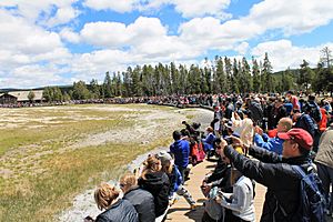 Tourists Viewing Old Faithful Eruption in 2019