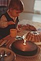 A young child preparing to extinguish the candle of his first birthday - 1983-11-30