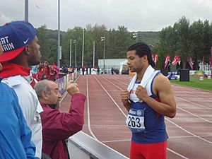 Sam Ruddock with coach Jim Edwards during the F35 Shot Put Final at Swansea 2014.jpg