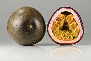 Photographs of a passionfruit in cross section and entire. The inner flesh is yellow and the exterior of the fruit is purple.