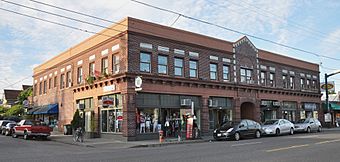 Photograph of a two-story, brick commercial building on an urban street corner