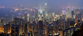 A full scene overlooking the skyscrapers of Hong Kong at night, with Victoria Harbour in the background