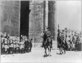 Gen. Pershing riding through Arc de Triomphe in parade with aide-de-camp George C. Marshall. LCCN2016652673