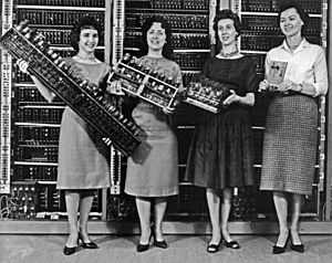 Women holding parts of the first four Army computers