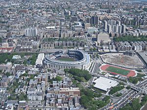 Yankee Stadium (center); Bronx County Courthouse and the Grand Concourse (towards the top); and the site of Yankee Stadium's predecessor to the far right. View is from the northwest, looking to the southeast, with Rikers Island and Queens visible in the upper right corner.