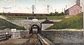 alt=A postcard with a frontal view of a train emerging from a tunnel