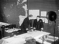 Staff officers discuss convoy movements in the Operations Room at HQ Western Approaches Command, Derby House, Liverpool, September 1944. A25742