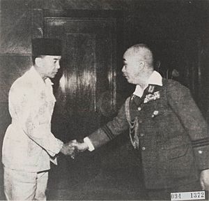 Soekarno shakes hand with Moichiri Yamamoto