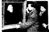Photograph of two artists, the Colquhouns, examining a painting