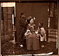 Manchu lady having her hair styled. John Thomson. China, 1869. The Wellcome Collection, London