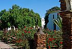 Garden and Pepper Tree, Mission San Luis Rey, CA 9-16 (30824095672) (cropped).jpg