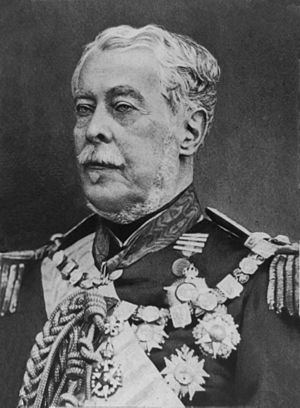 Half-length photographic portrait of an older man dressed in a military tunic with medals, chain of office and sash