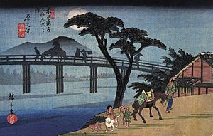 Hiroshige Man on horseback crossing a bridge