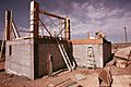 EXTERIOR OF AN EXPERIMENTAL ALL ALUMINUM BEER AND SOFT DRINK CAN HOUSE UNDER CONSTRUCTION NEAR TAOS, NEW MEXICO. THIS... - NARA - 556642