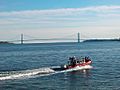 United States Coast Guard on patrol in Upper New York Bay. The Verrazzano-Narrows Bridge across the Narrows is visible in the background.