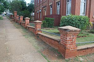Brick fence located S and E of the former Technical College Building, from SE (2015)