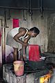 A man dyeing silk red in boiling water in Kumbakonam, Tamil Nadu
