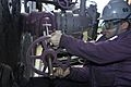 USN sailor operates fuel valve · 070115-N-9479M-004