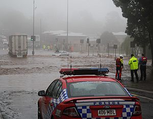 Trapped woman on a car roof during flash flooding in Toowoomba 1